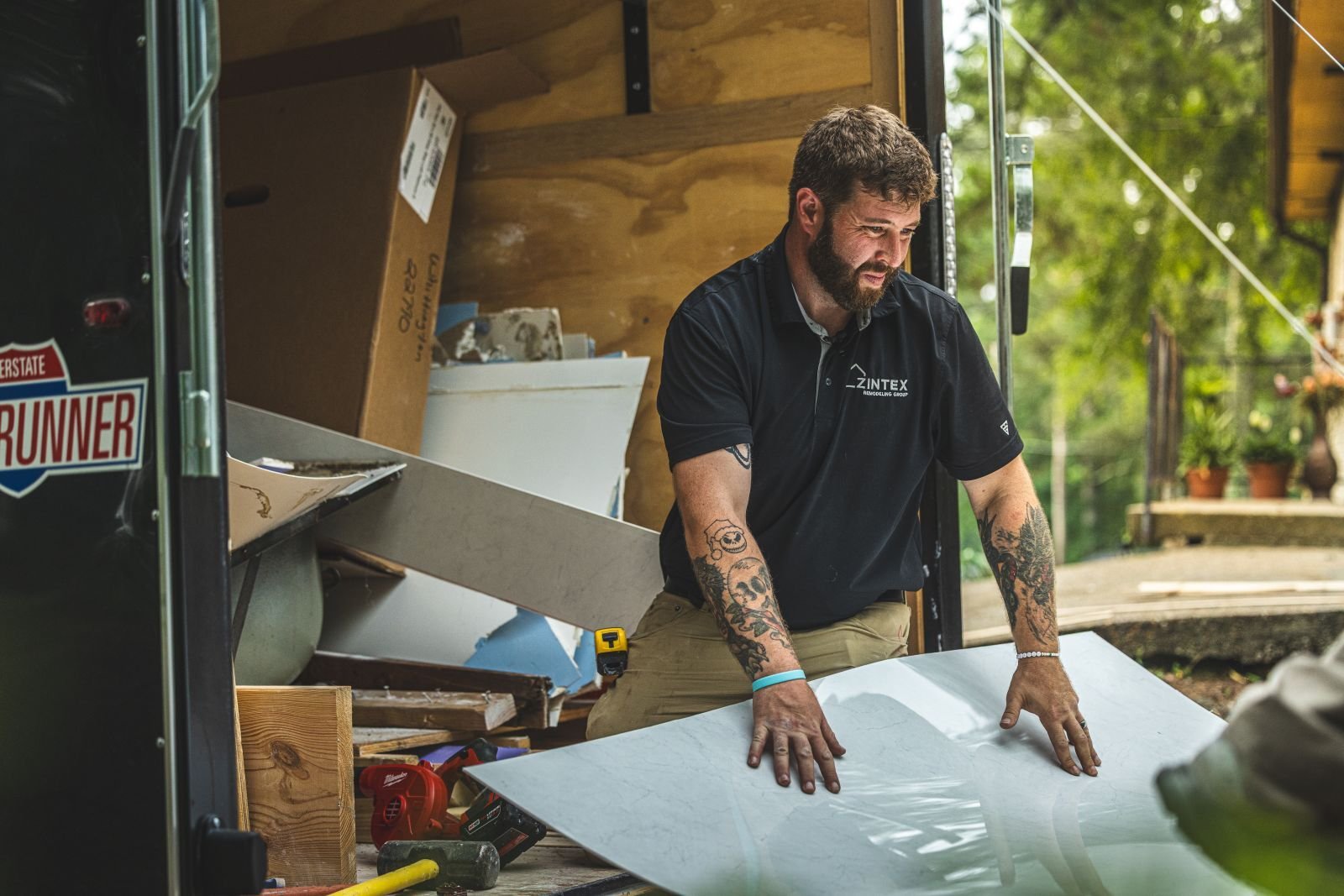 Photo of a Zintex shower installer doing a quality control check on walk in shower materials