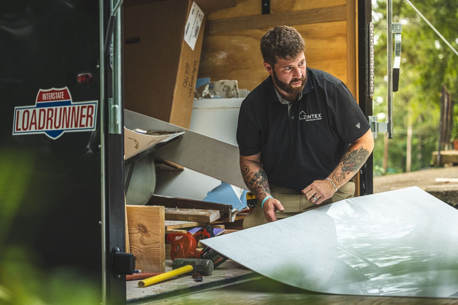 Photo of a Zintex shower installer conducting an acrylic walk in shower material quality control check