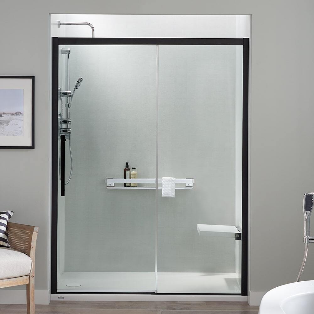 Walk in shower with glass enclosure with a matte black frame