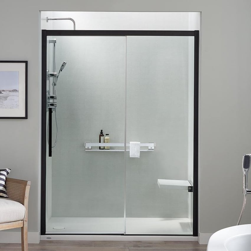 Walk in shower with glass enclosure with a matte black frame