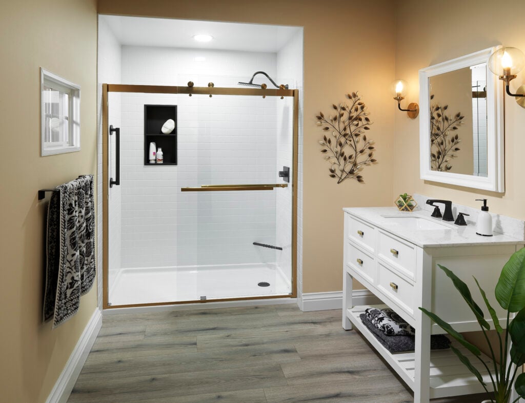 Photo of a spacious bathroom with an acrylic walk in shower that has a glass sliding door