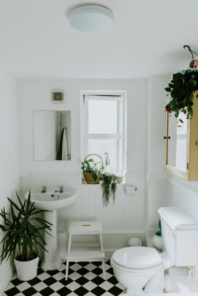 Photo of a small bathroom with white walls and ample natural lighting Photo by Phil Hearing on Unsplash