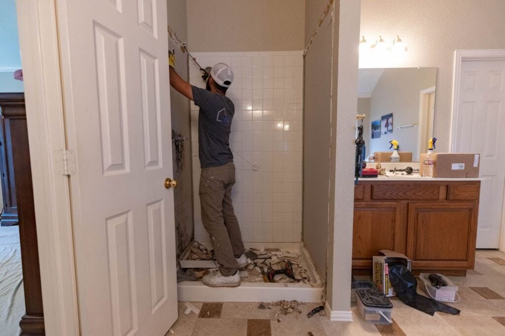 Photo of a ZINTEX contractor installing a new walk in shower