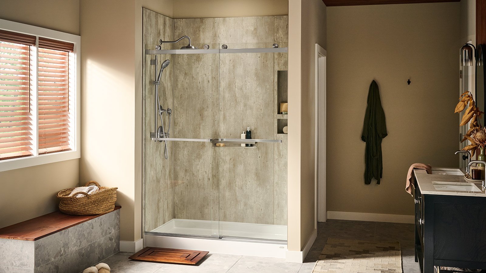 Photo of a bathroom with a walk in shower on the far wall. The shower has a sliding glass door and silver hardware