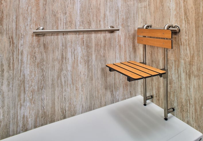 Close up photo of a fold-down seat in a walk in shower with Jacuzzi Seaside acrylic walls