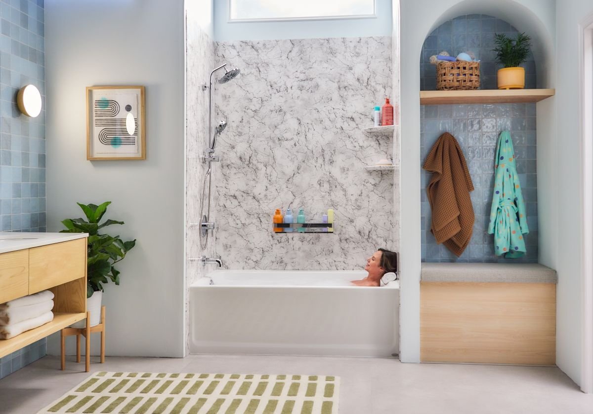 Photo of a woman relaxing in a tub and shower combo with a Jacuzzi tub and Jacuzzi acrylic shower wall panels