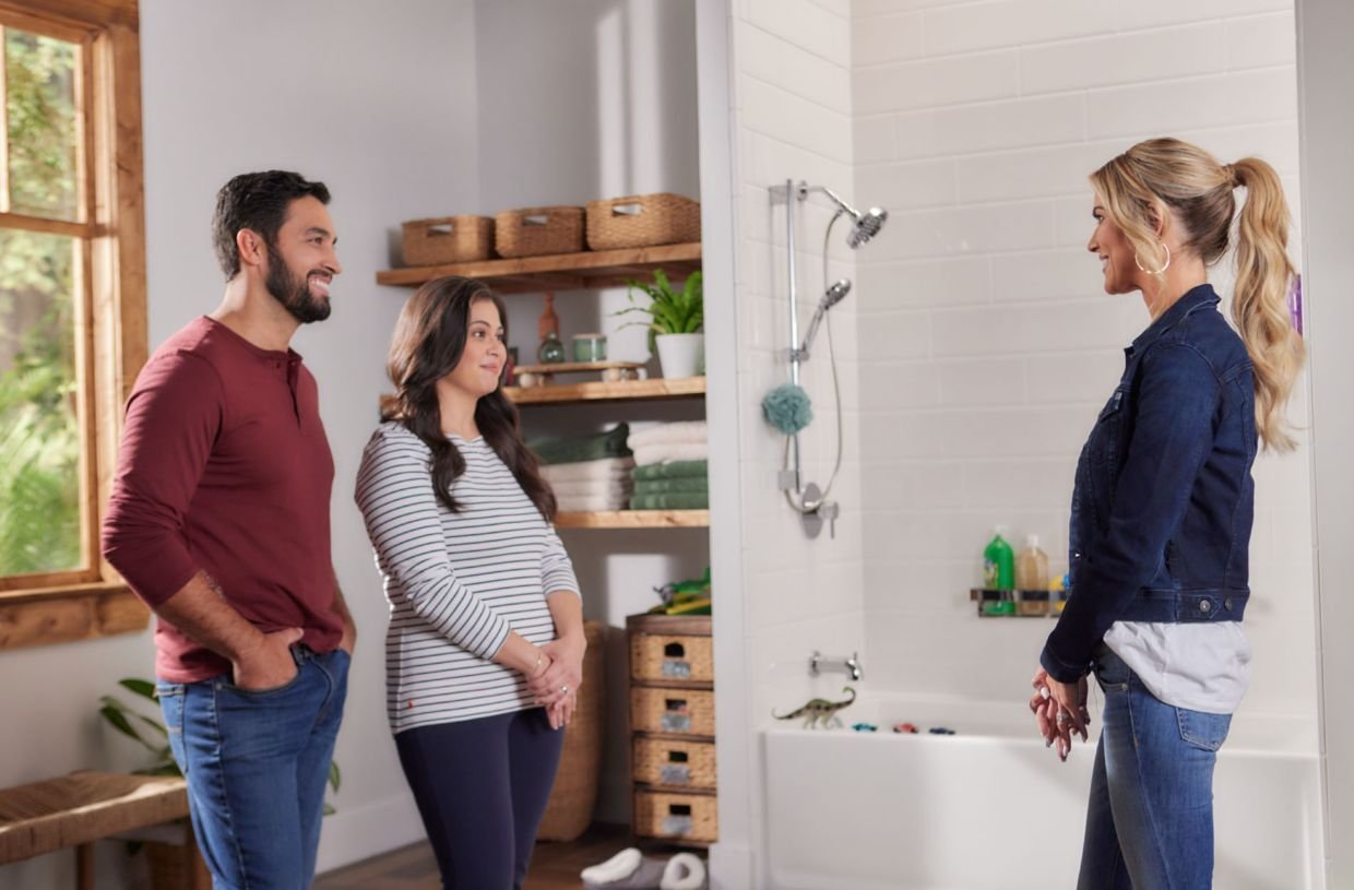 Project manager with a couple in front of their new tub shower combo by Jacuzzi