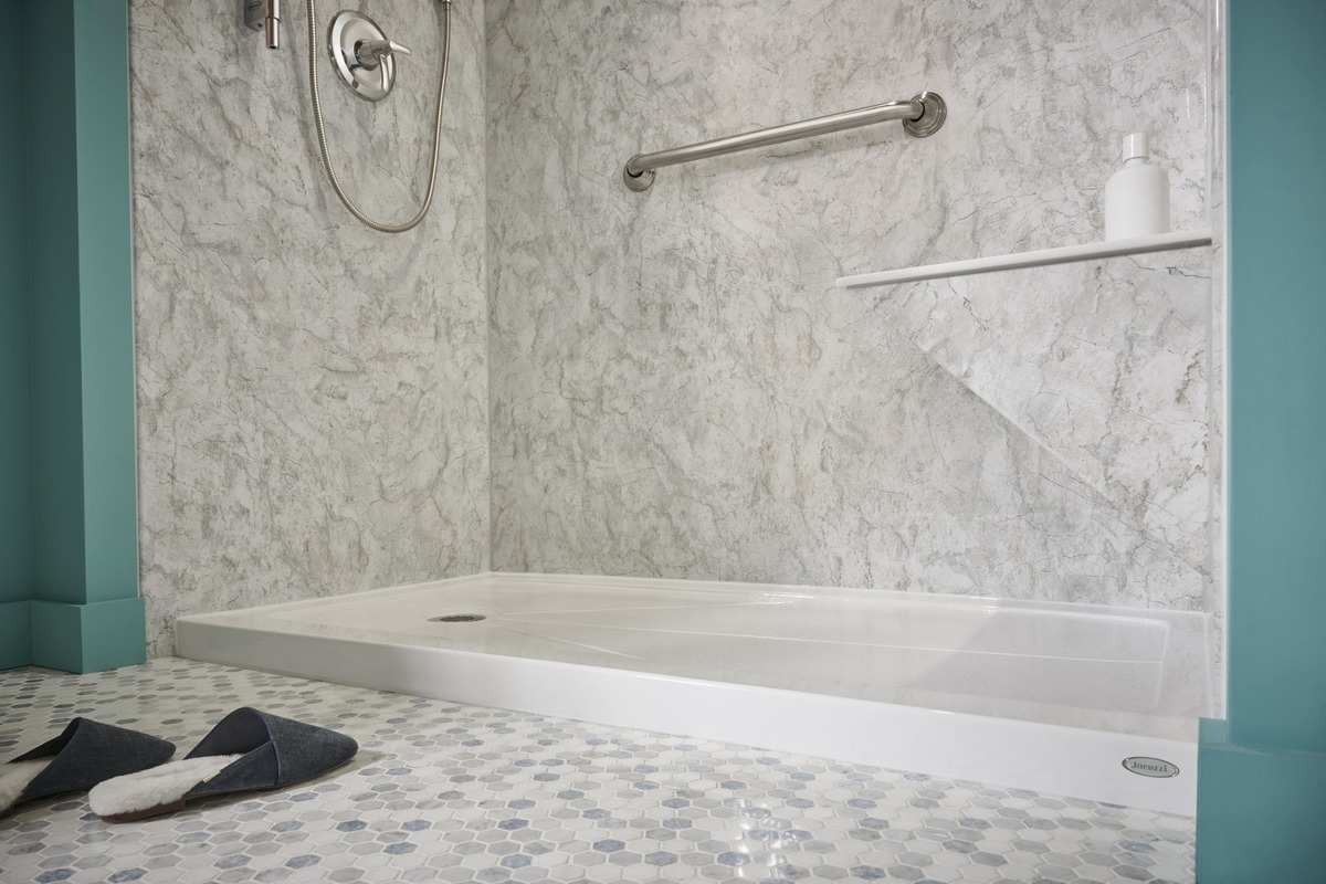 Photo showing the low threshold entry in a walk in shower with built in seating for senior accessibility