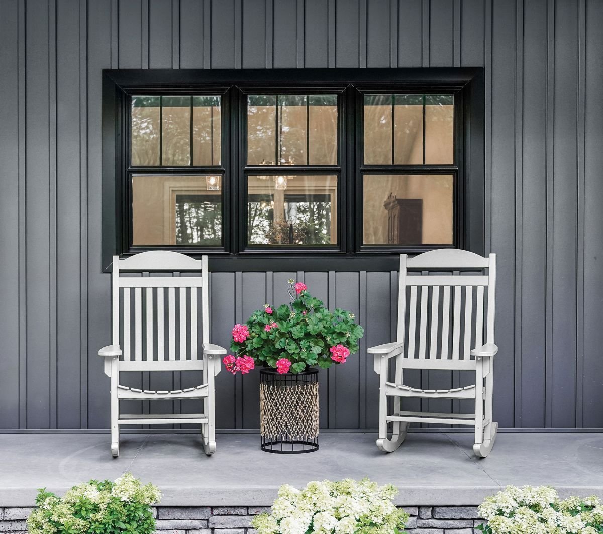 Photo of home exterior and three windows with black frames